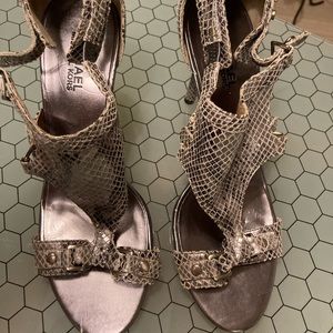 Lovely and fancy high heeled sandals by Michael Kors silver, gently used.
